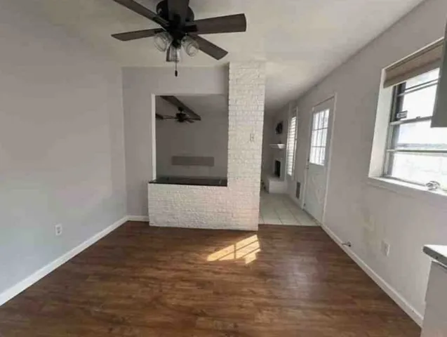 a view of a hallway view with wooden floor and staircase