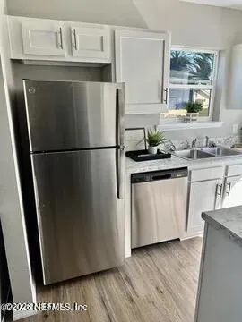 a white refrigerator freezer sitting inside of a kitchen