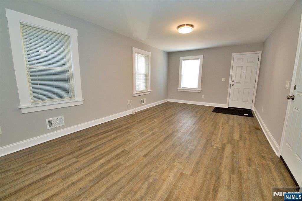 116 Maple Avenue, Unit 4 Montclair, NJ 07042 - Photo 3 of 14 a view of an empty room with wooden floor and a window
