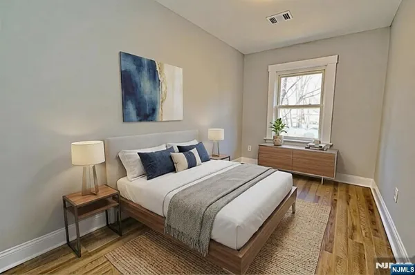 a view of a room with wooden floor and windows