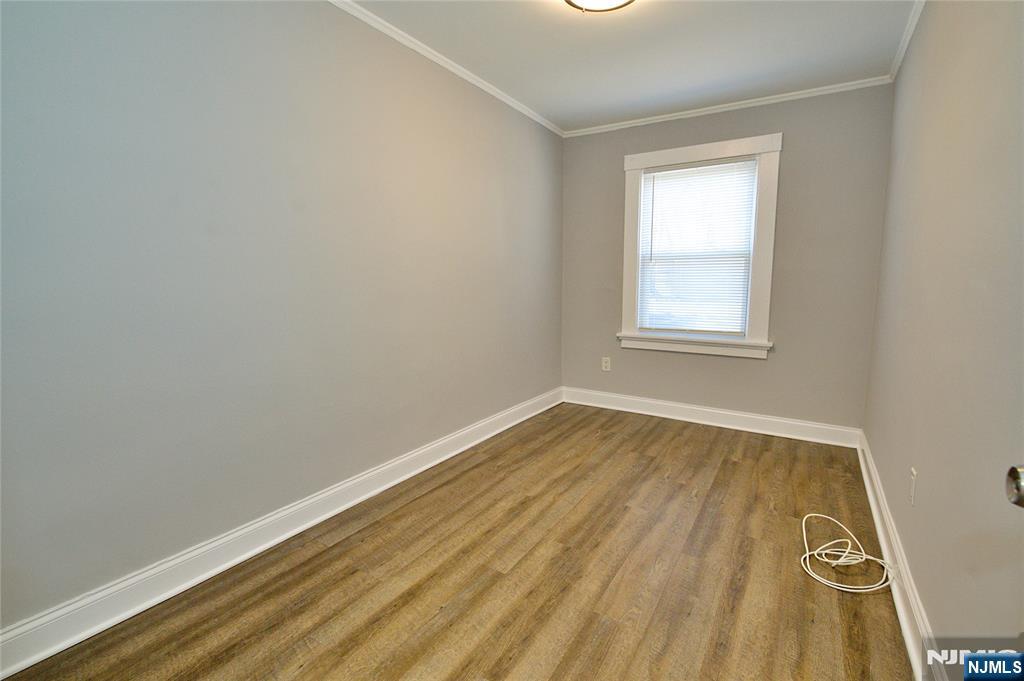 116 Maple Avenue, Unit 4 Montclair, NJ 07042 - Photo 9 of 14 an empty room with wooden floor and windows