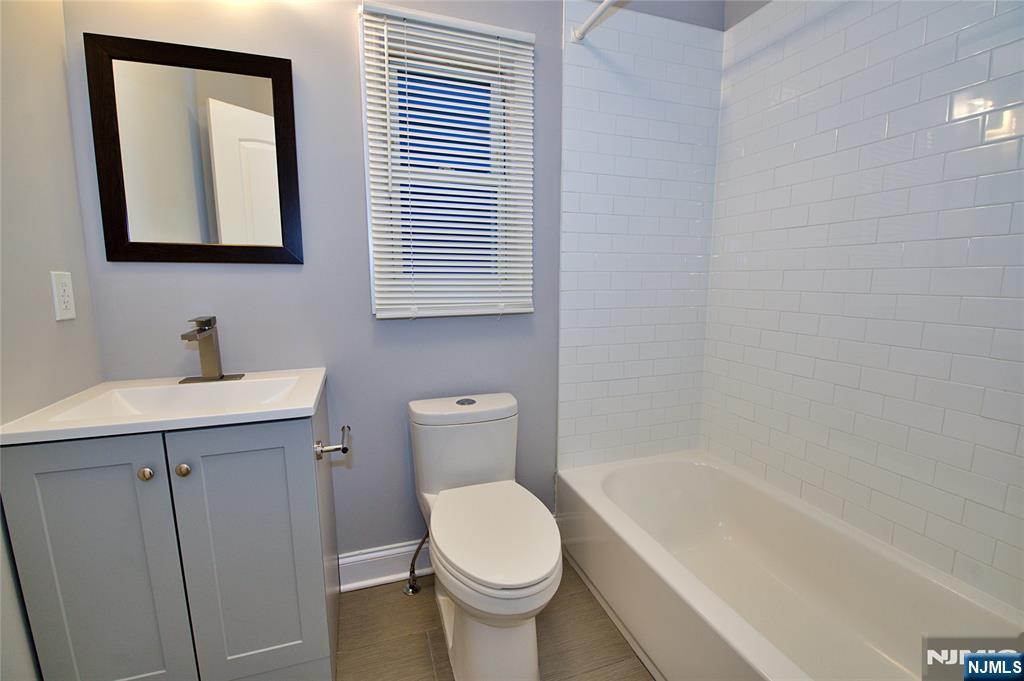 116 Maple Avenue, Unit 4 Montclair, NJ 07042 - Photo 10 of 14 a bathroom with a toilet sink and mirror