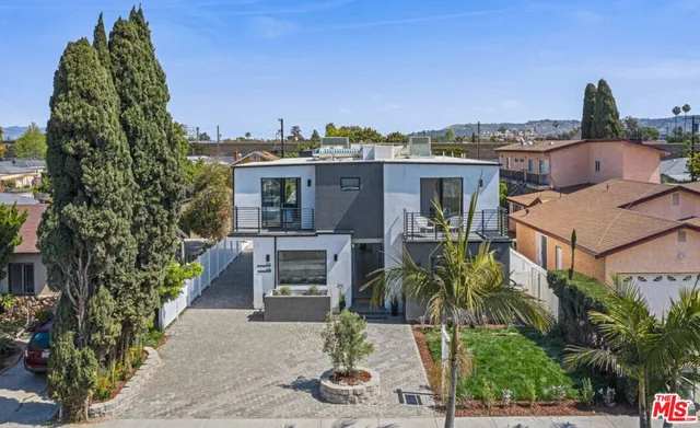 a front view of a house with a garden