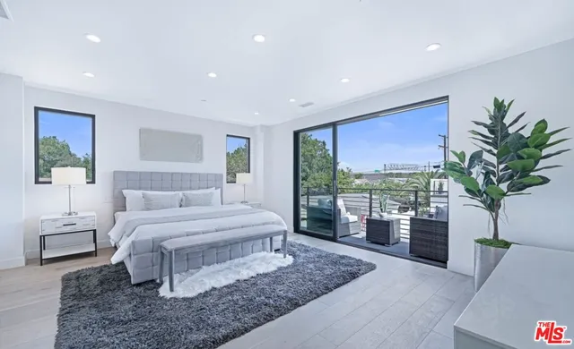 a bedroom with a large bed and a couch