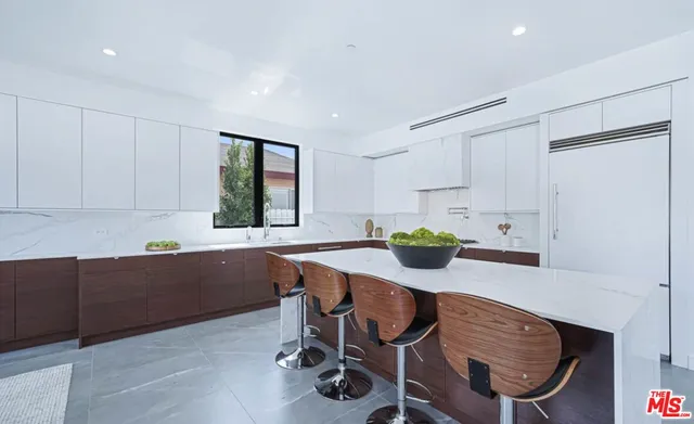a kitchen with a table chairs and a refrigerator