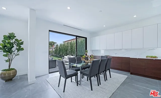 a view of a dining room with furniture and a potted plant