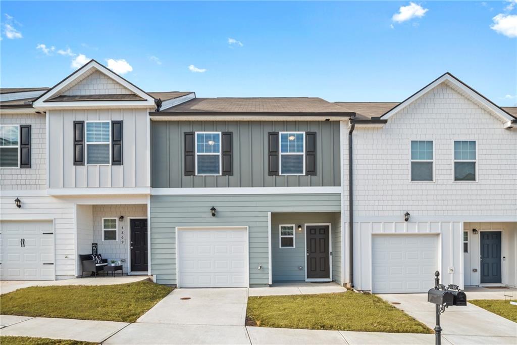 4867 Longleaf Road Atlanta, GA 30349 - Photo 1 of 1 a front view of a house with garden