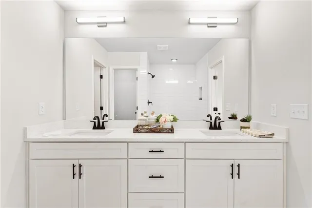 a bathroom with double sink and a mirror