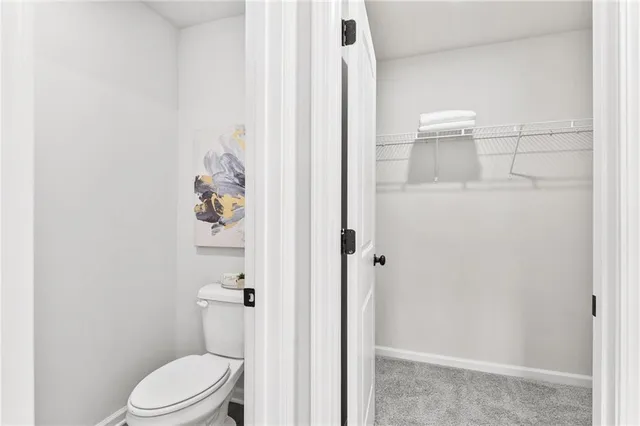 a white toilet sitting next to a bathroom sink