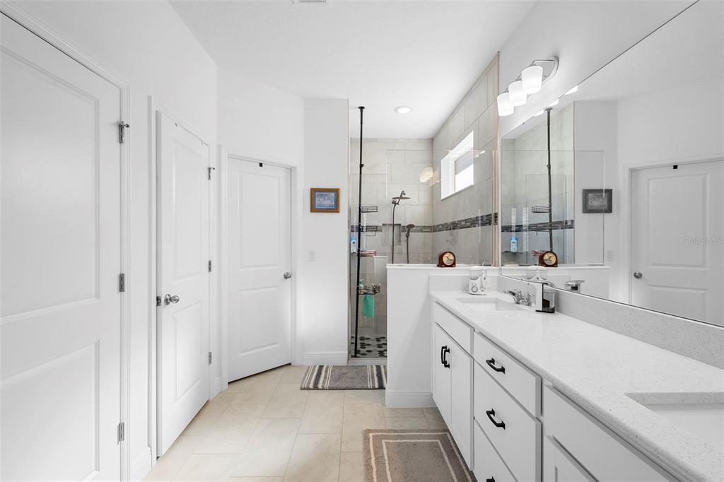 744 Hyperion Drive DeBary, FL 32713 - Photo 24 of 54 a spacious bathroom with double vanity and mirrors