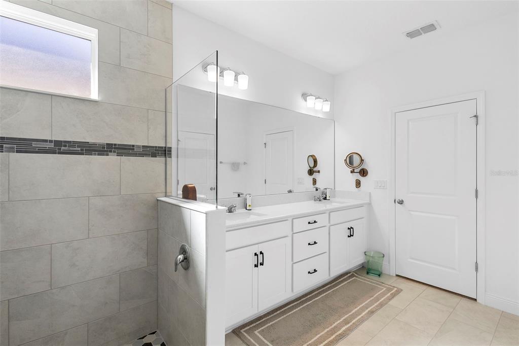 744 Hyperion Drive DeBary, FL 32713 - Photo 26 of 54 a spacious bathroom with double sink and a mirror