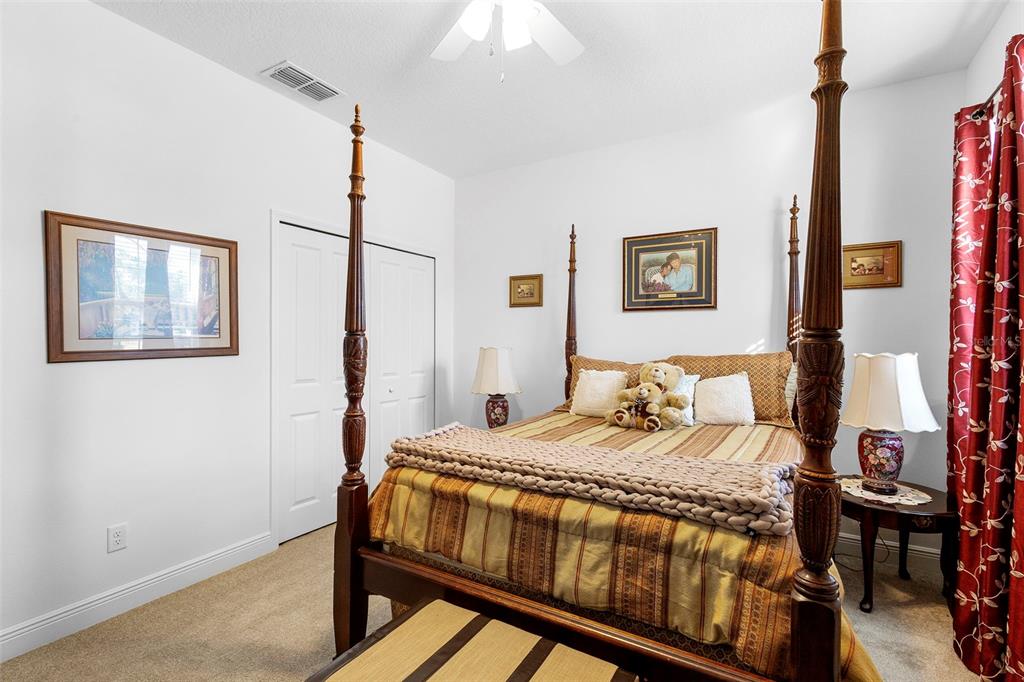 744 Hyperion Drive DeBary, FL 32713 - Photo 30 of 54 a bedroom with a bed and a painting on the wall