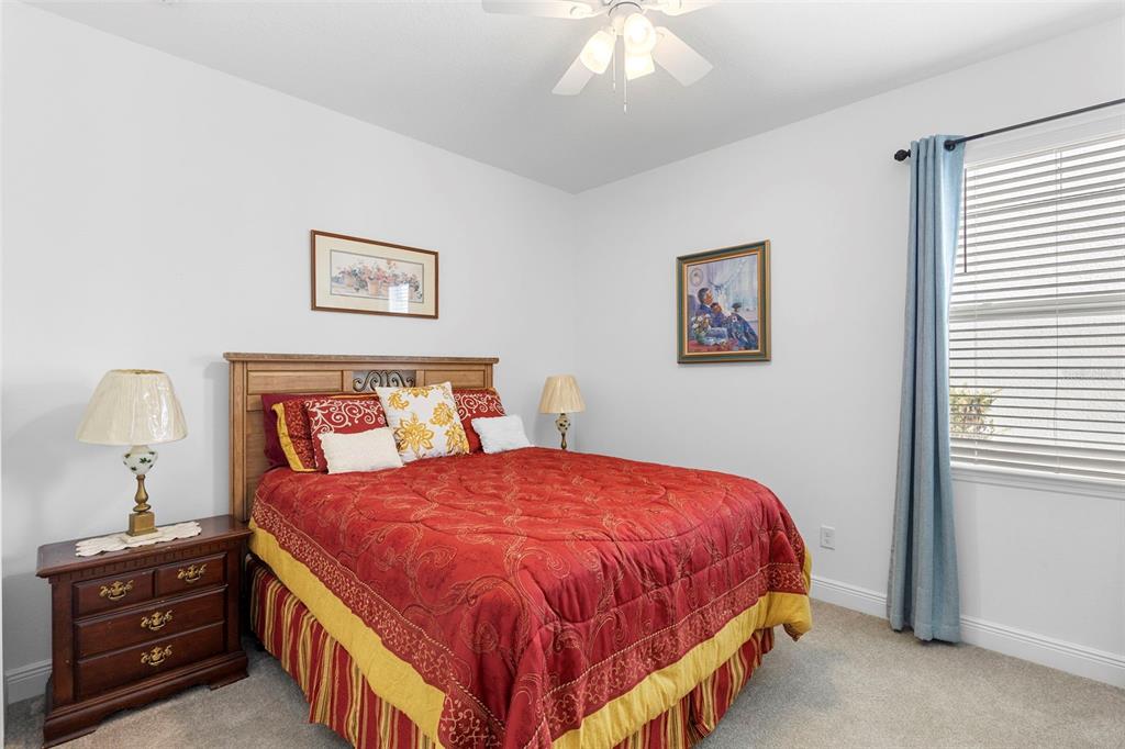 744 Hyperion Drive DeBary, FL 32713 - Photo 31 of 54 a bedroom with a bed and a chandelier