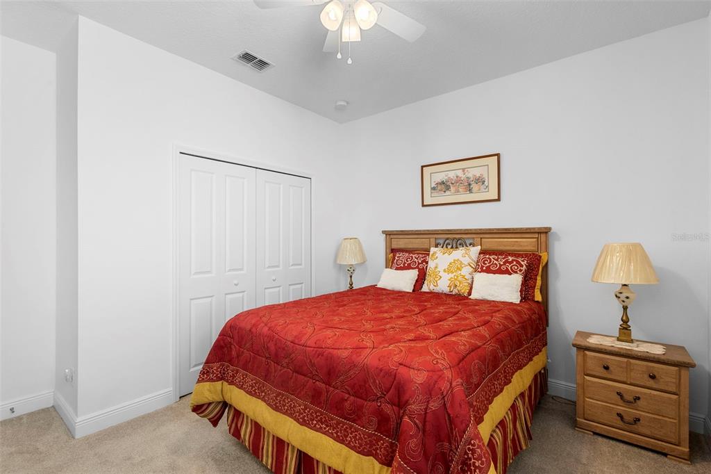 744 Hyperion Drive DeBary, FL 32713 - Photo 32 of 54 a bedroom with a bed and a chandelier