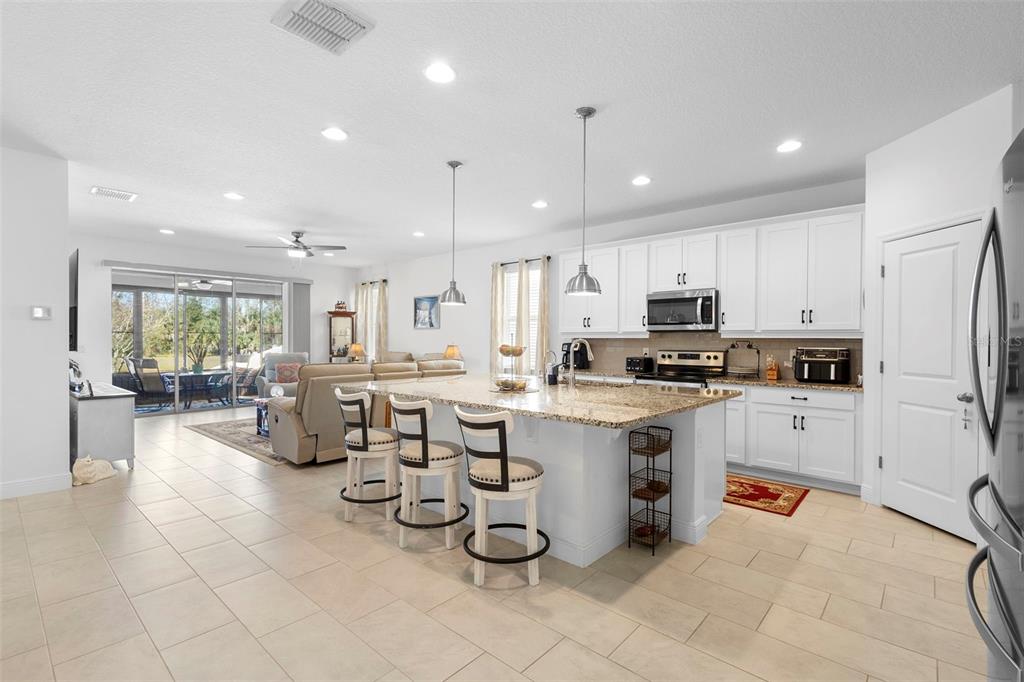 744 Hyperion Drive DeBary, FL 32713 - Photo 8 of 54 a kitchen with white cabinets and appliances