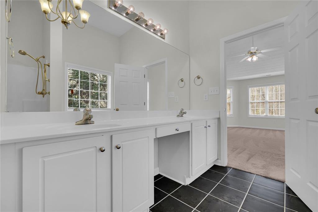 201 Wisteria Way Athens, GA 30606 - Photo 15 of 38 a bathroom with a double vanity sink a mirror and a shower