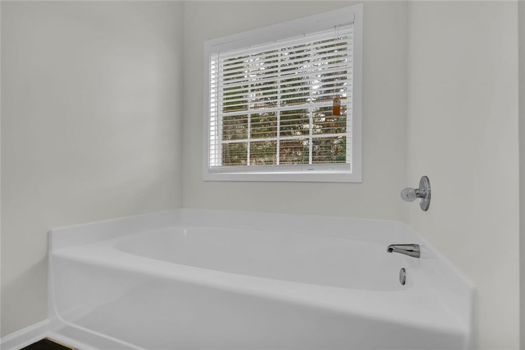 201 Wisteria Way Athens, GA 30606 - Photo 16 of 38 a white bath tub sitting next to a window