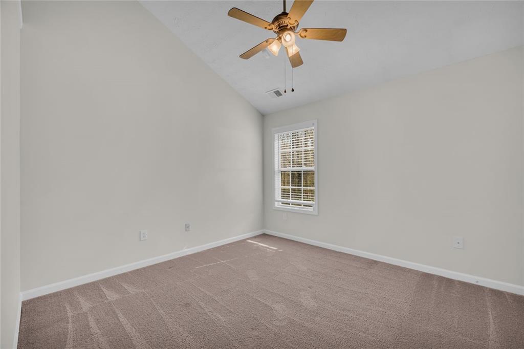 201 Wisteria Way Athens, GA 30606 - Photo 18 of 38 an empty room with a window and a fan