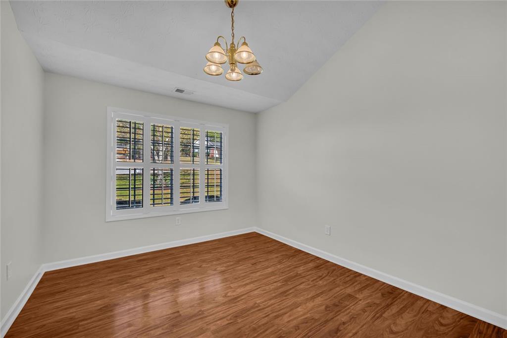 201 Wisteria Way Athens, GA 30606 - Photo 23 of 38 a view of an empty room with wooden floor and a window