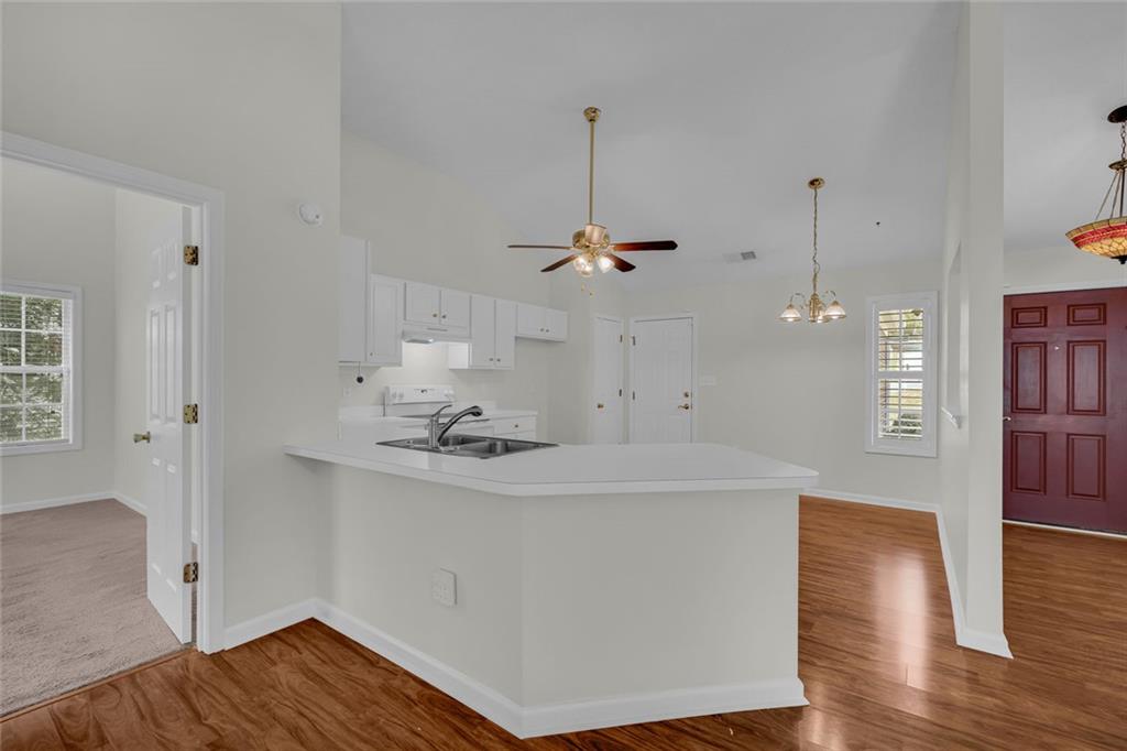 201 Wisteria Way Athens, GA 30606 - Photo 7 of 38 a view of a kitchen with a sink dishwasher a refrigerator and wooden floor