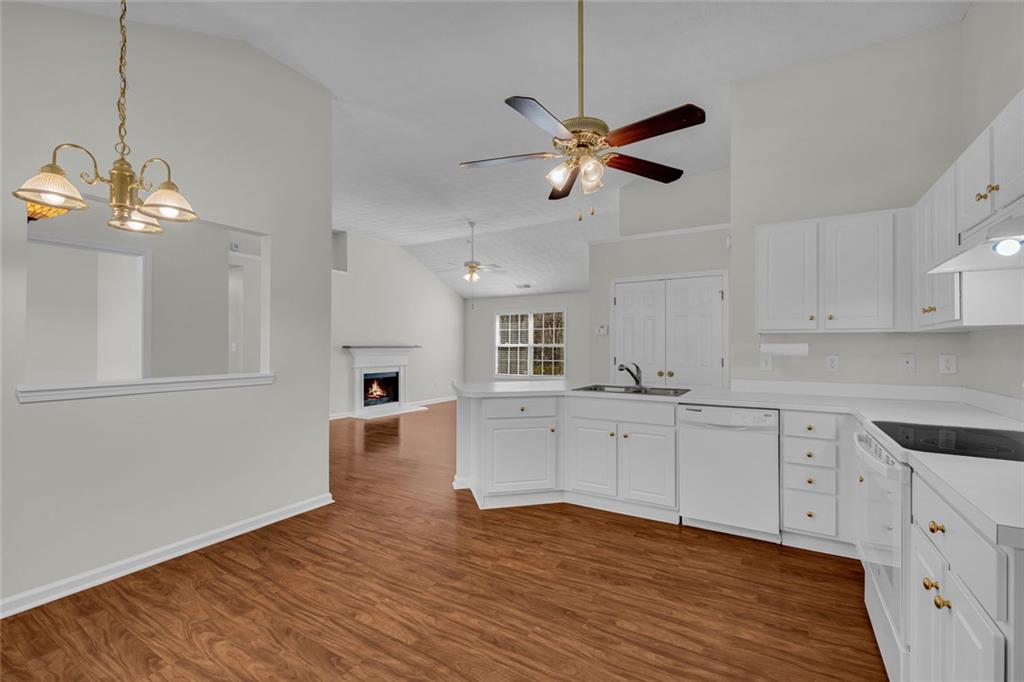 201 Wisteria Way Athens, GA 30606 - Photo 9 of 38 a kitchen with cabinets wooden floor and a ceiling fan