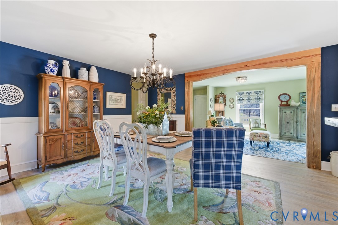 6606 West Quaker Road Disputanta, VA 23842 - Photo 11 of 32 Dining area featuring LVP floors, a chandelier, an
