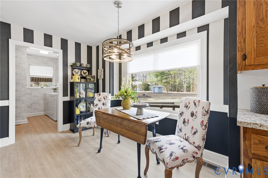 6606 West Quaker Road Disputanta, VA 23842 - Photo 16 of 32 Dining area featuring LVP flooring, large open win
