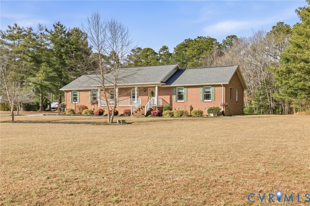 6606 West Quaker Road Disputanta, VA 23842 - Photo 2 of 32 Single story home with covered porch, a front yard