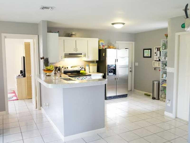 9293 Southampton Place Boca Raton, FL 33434 - Photo 2 of 12 a kitchen with stainless steel appliances a refrigerator sink and cabinets