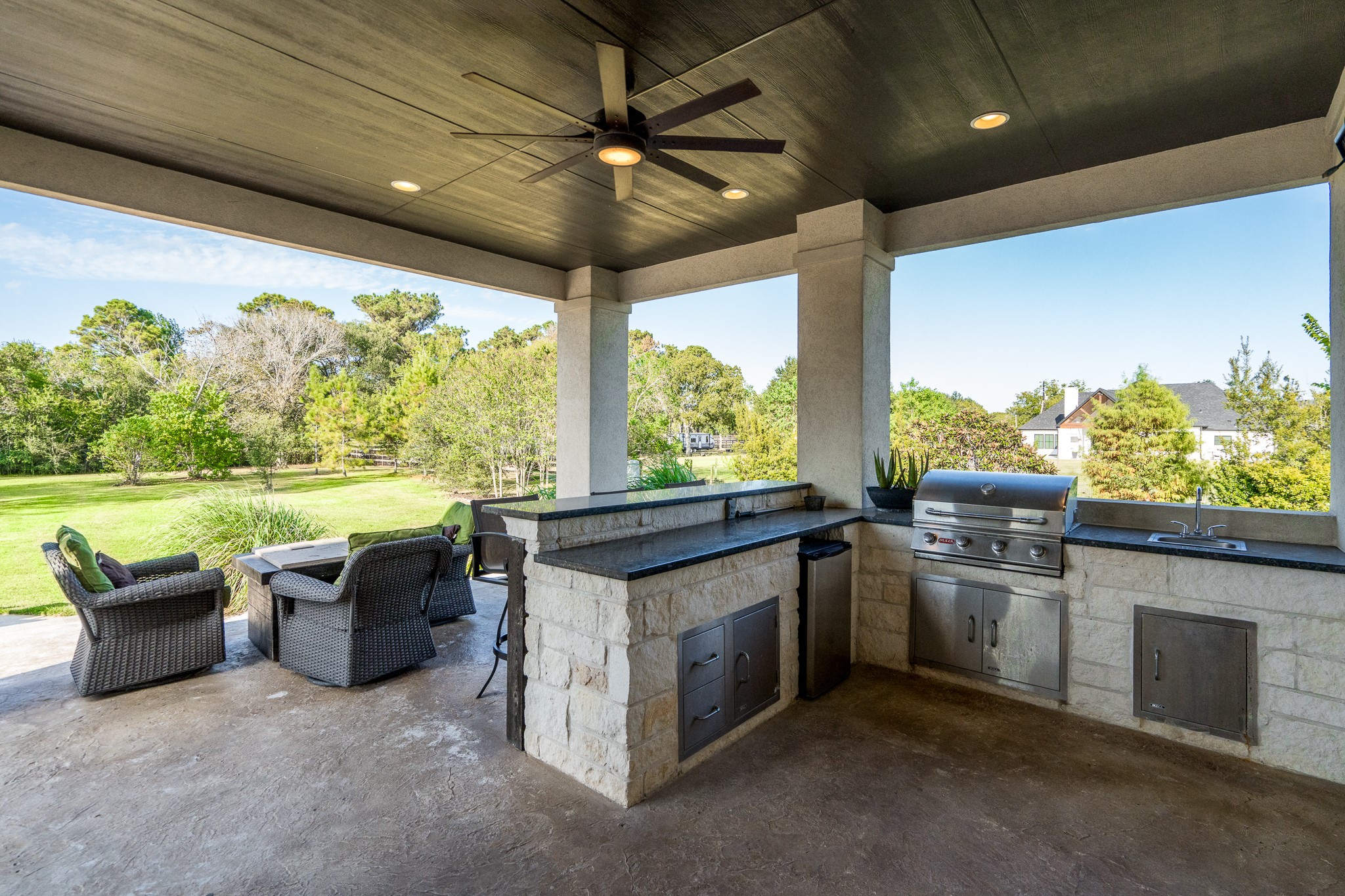 12748 Roy Road Pearland, TX 77581 - Photo 13 of 50 Summer kitchen includes stainless appliances and sink.