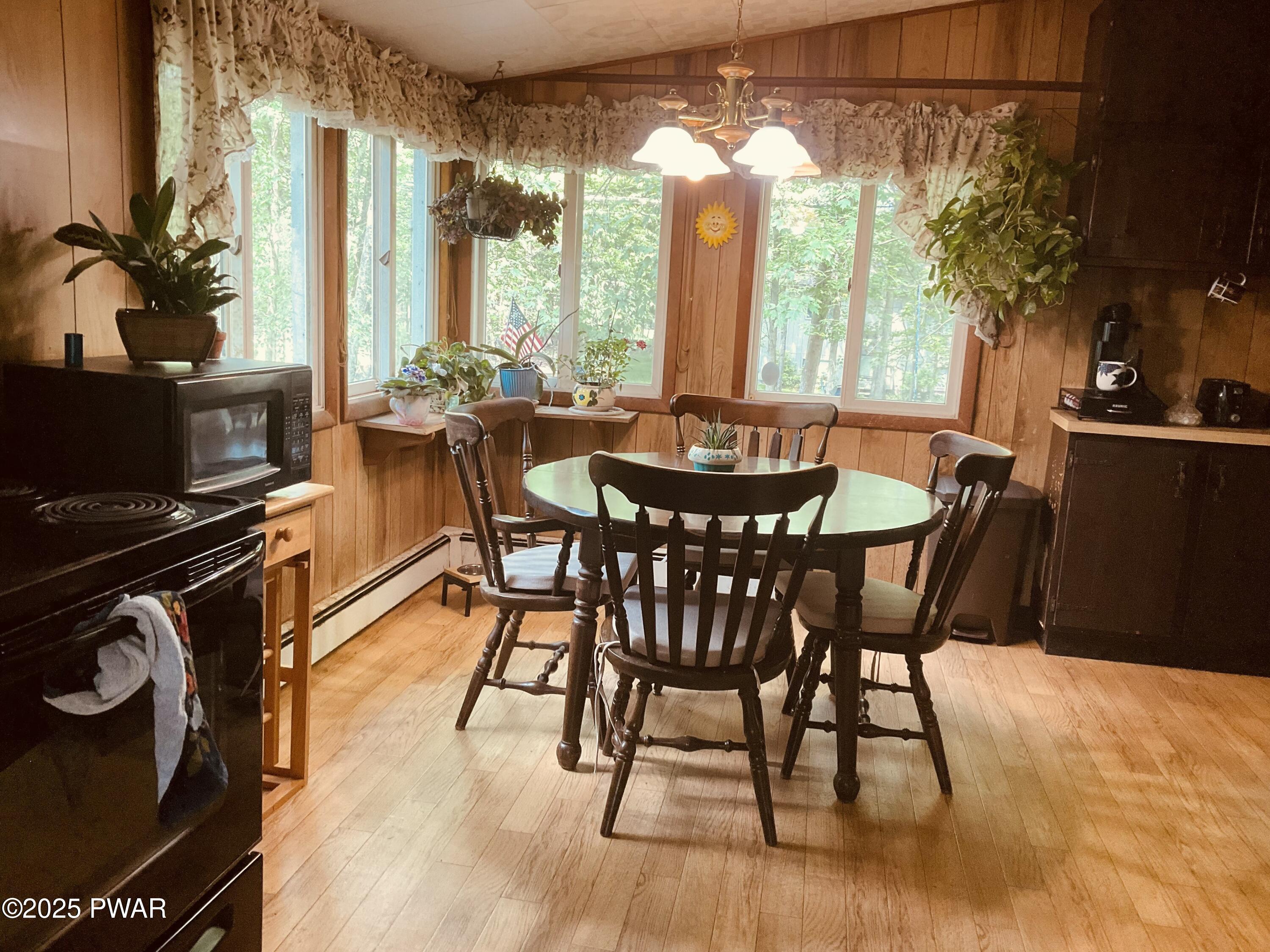 124 Roundhill Road Dingmans Ferry, PA 18328 - Photo 7 of 47 a view of a dining room with furniture and chandelier