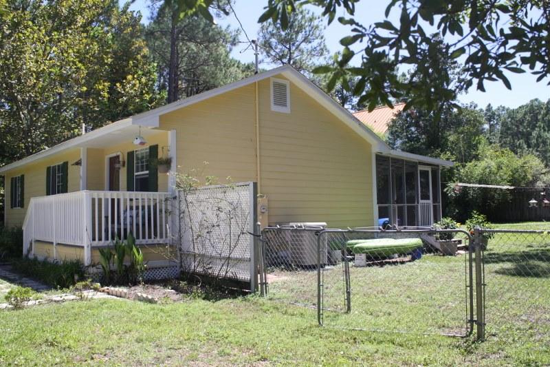53 Mandy Circle Santa Rosa Beach, FL 32459 - Photo 2 of 13 a backyard of a house with table and chairs
