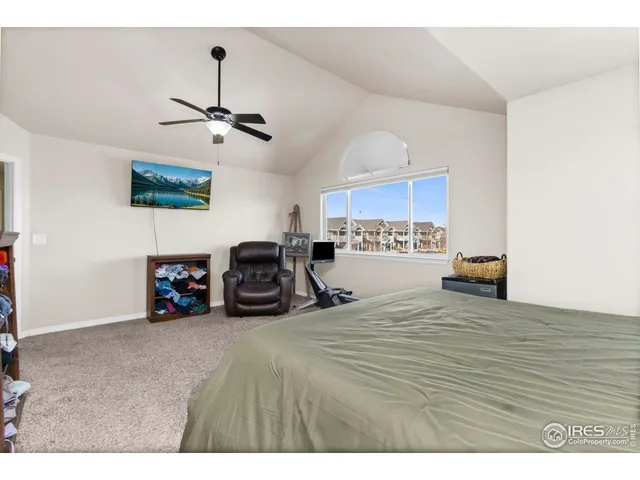 a bedroom with a bed and a painting on the wall