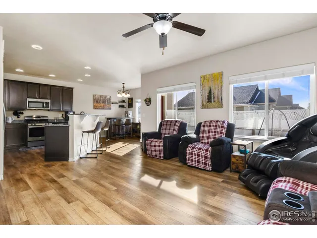 a living room with furniture and kitchen view