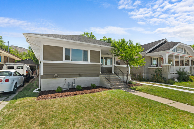 2862 Fowler Avenue Ogden, UT 84403 - Photo 4 of 23 Contemporary exterior with olive green siding, white trim, and a dark shingle roof
