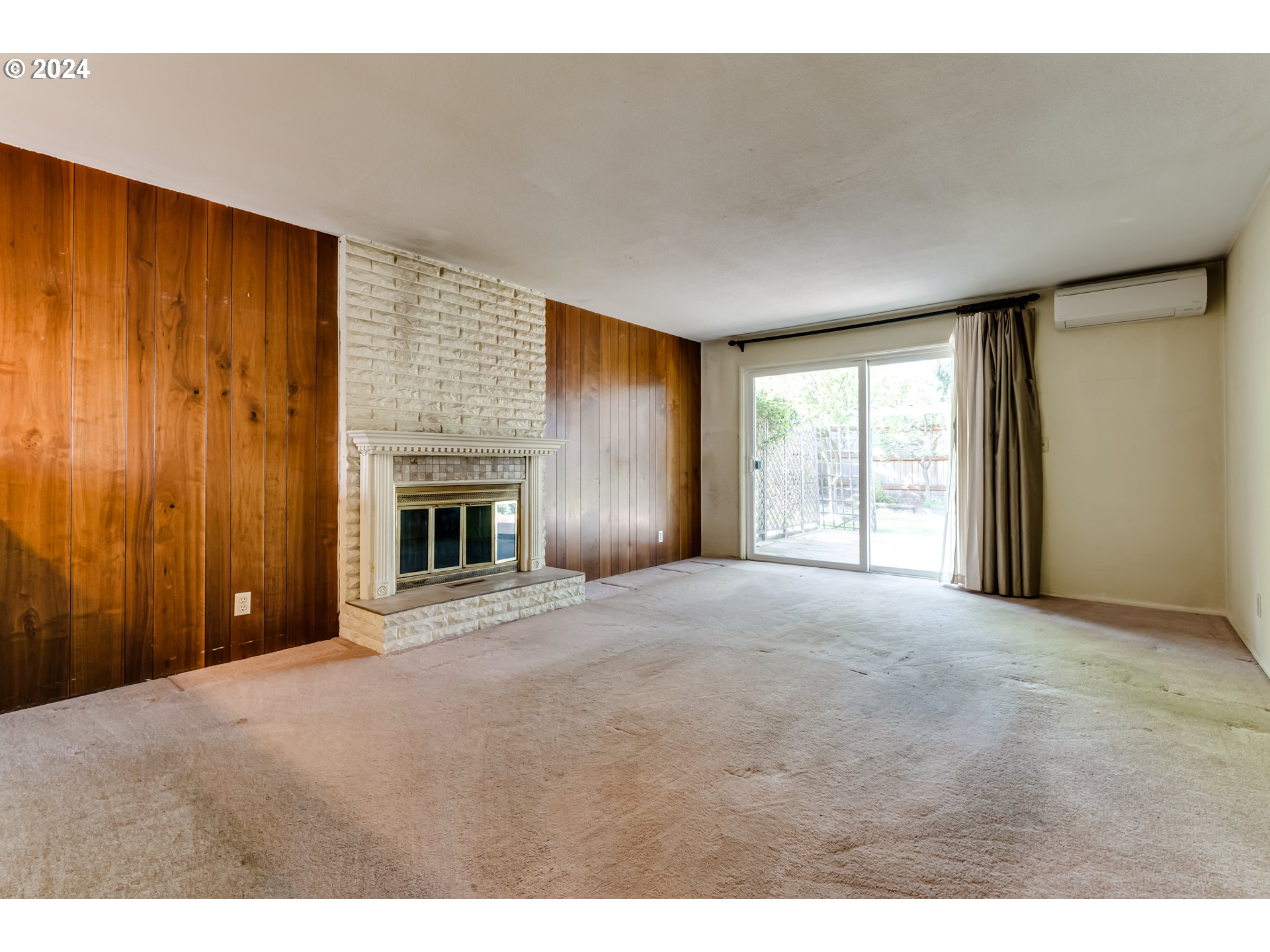 125 East 39th Place Eugene, OR 97405 - Photo 5 of 30 a view of an empty room with a window and fireplace