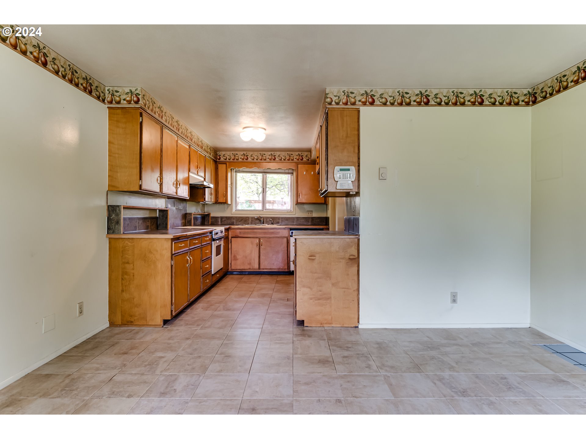 125 East 39th Place Eugene, OR 97405 - Photo 9 of 30 a kitchen with granite countertop a refrigerator a sink a stove top oven and cabinetry