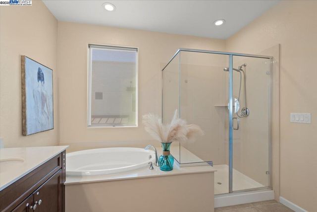 a bathroom with a shower a sink and a mirror