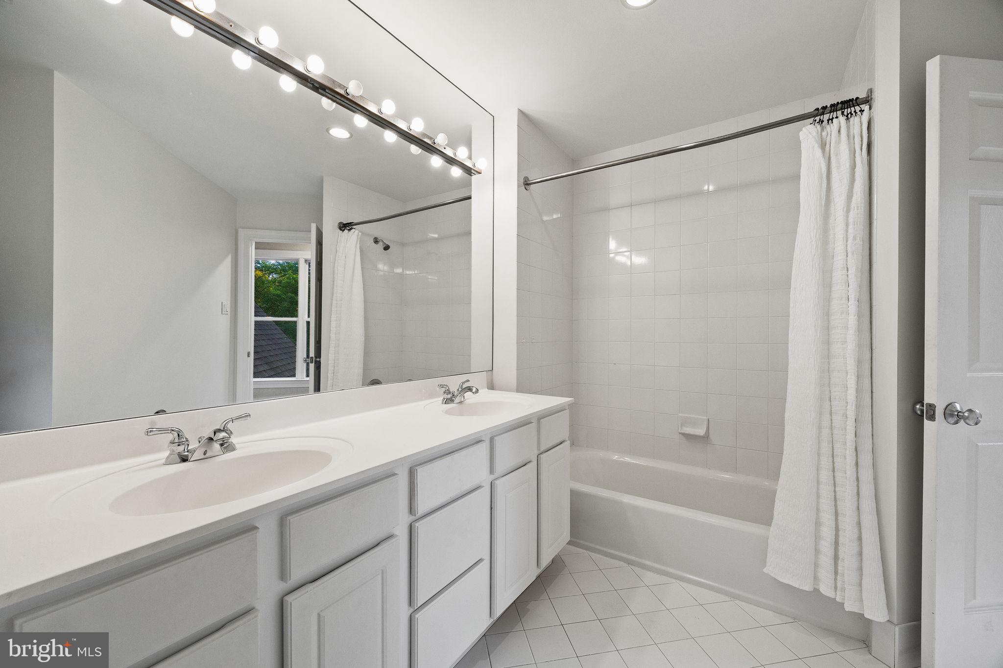 484 King Of Prussia Road Wayne, PA 19087 - Photo 43 of 98 a bathroom with a double vanity sink mirror double and shower