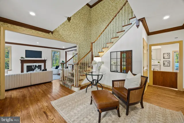 a living room with furniture large window and a fireplace