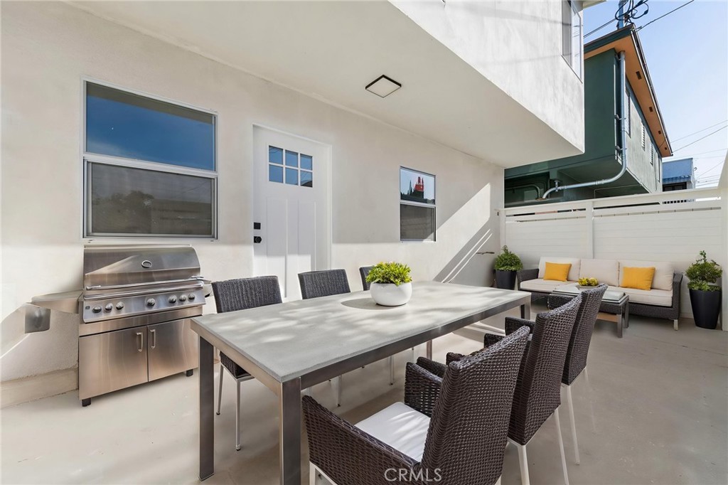 3020 East 3rd Street Long Beach, CA 90814 - Photo 15 of 63 a kitchen with a stove a table and chairs