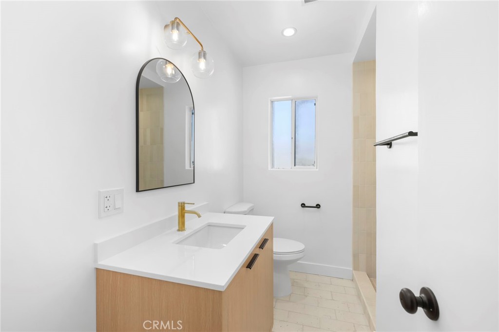 3020 East 3rd Street Long Beach, CA 90814 - Photo 28 of 63 a bathroom with a sink and a mirror