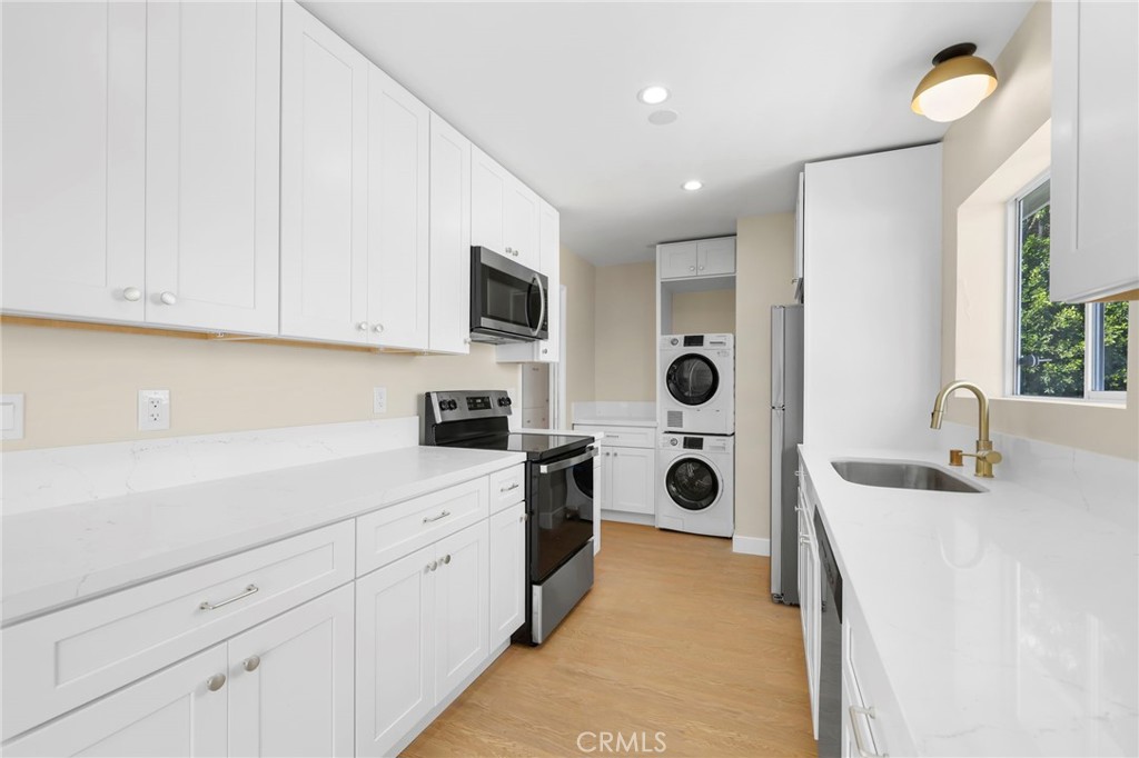 3020 East 3rd Street Long Beach, CA 90814 - Photo 30 of 63 a kitchen with white cabinets and window