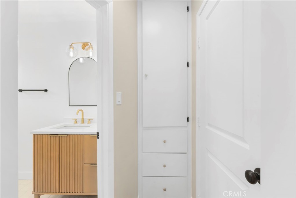 3020 East 3rd Street Long Beach, CA 90814 - Photo 44 of 63 a bathroom with a sink and a mirror