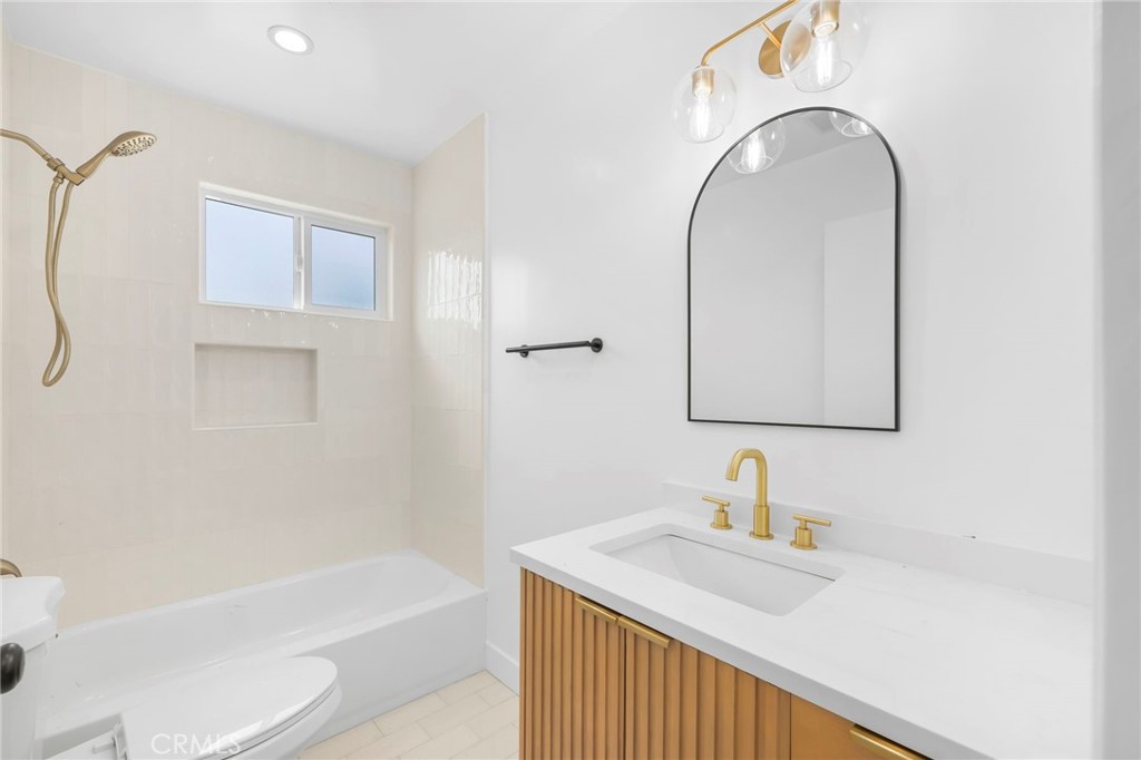 3020 East 3rd Street Long Beach, CA 90814 - Photo 45 of 63 a bathroom with a sink and a mirror