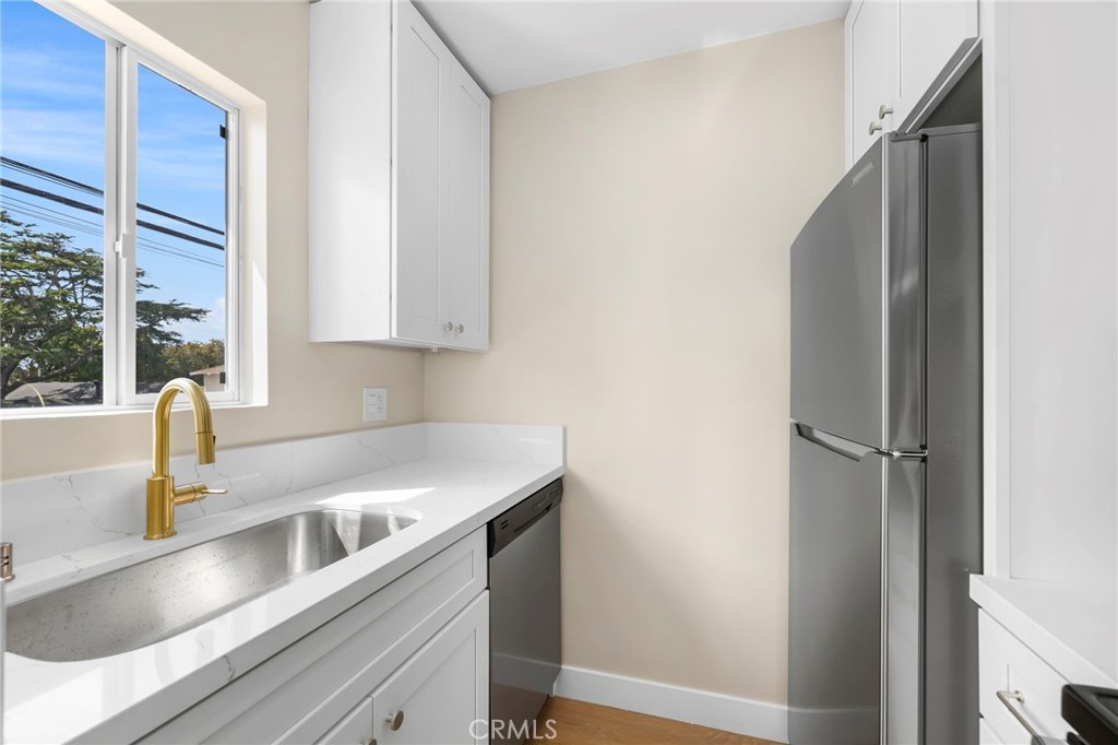 3020 East 3rd Street Long Beach, CA 90814 - Photo 49 of 63 a kitchen with a sink and a refrigerator