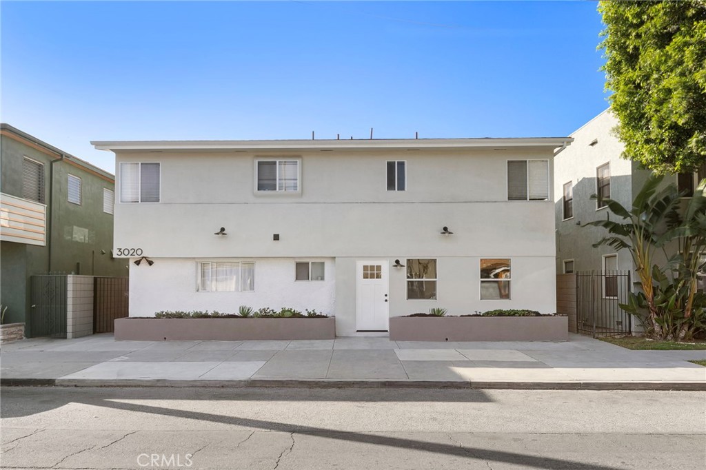3020 East 3rd Street Long Beach, CA 90814 - Photo 60 of 63 a front view of a house with a yard