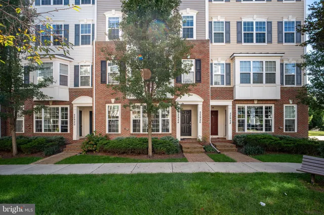 a front view of a residential apartment building with a yard