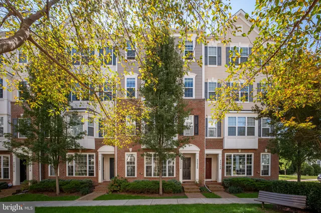 front view of a brick building next to a yard