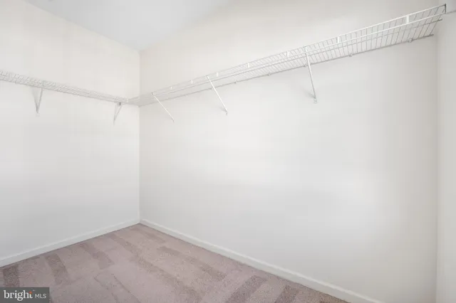 a view of a livingroom with a ceiling fan and window